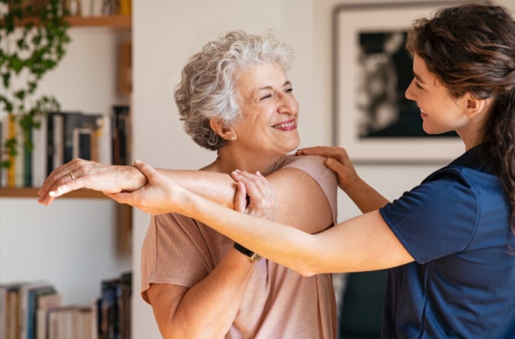 older Lady is getting help from a female chiropractor